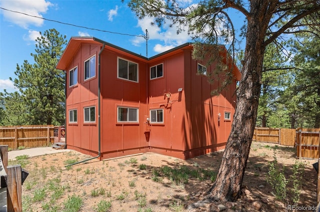 561 Quartz Cir, Bailey, CO 80421 - back of house with a fenced backyard and board and batten siding