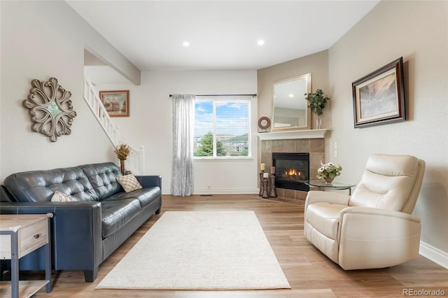 737 Novick Ct, Castle Rock, CO 80109 - living area featuring light wood-style flooring, baseboards, a tiled fireplace, and recessed lighting