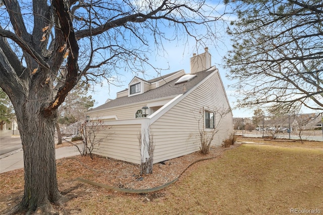 view of side of property with a yard