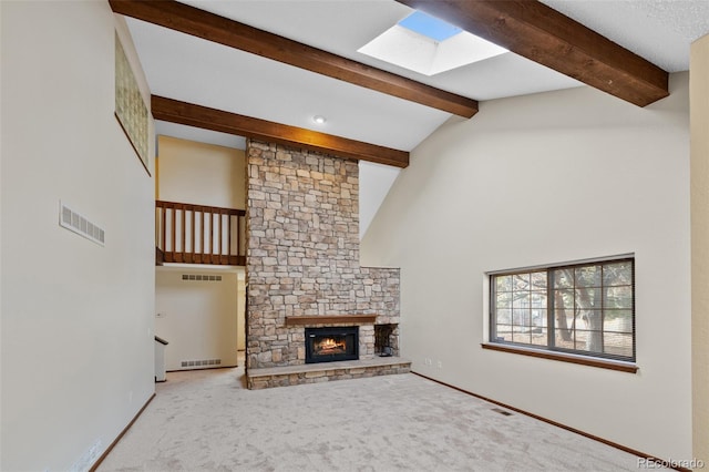 unfurnished living room featuring a stone fireplace, carpet flooring, high vaulted ceiling, and beam ceiling