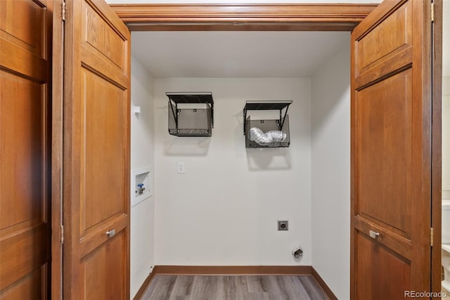 washroom with hookup for an electric dryer, light hardwood / wood-style floors, and hookup for a washing machine