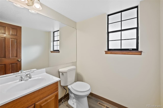 bathroom featuring hardwood / wood-style flooring, vanity, and toilet