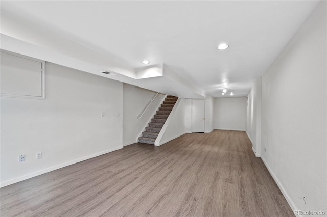 basement featuring light hardwood / wood-style floors