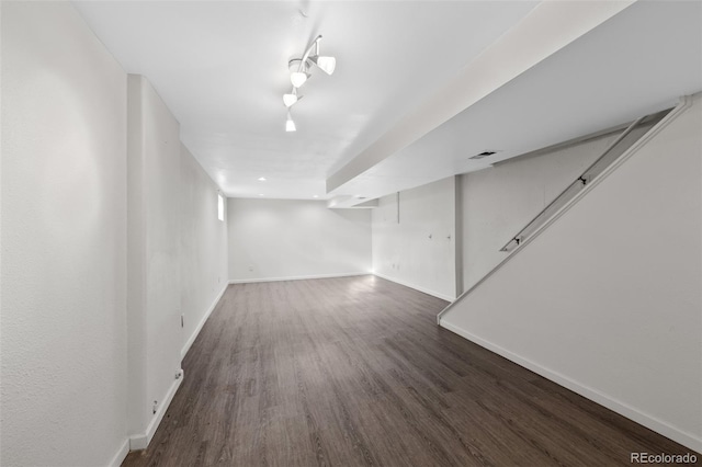 basement featuring dark hardwood / wood-style flooring