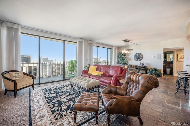 1020 15th St Unit 42C, Denver, CO 80202 - living room with healthy amount of natural light, a chandelier, a wall of windows, and a city view