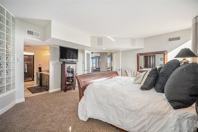 carpeted bedroom with ensuite bath