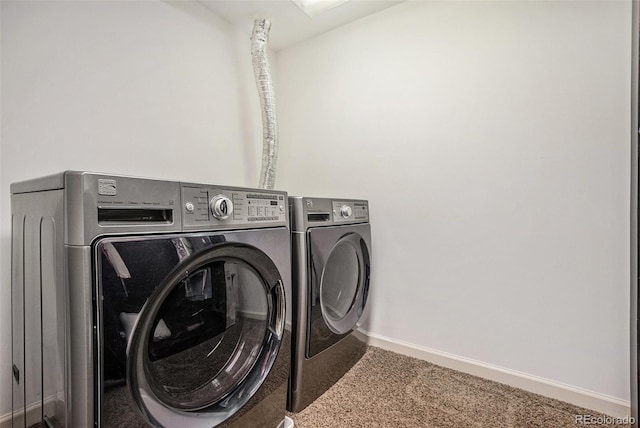 laundry area featuring washer and clothes dryer and carpet