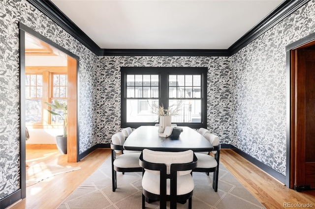 dining area featuring hardwood / wood-style flooring and crown molding