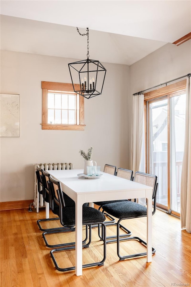 dining area featuring an inviting chandelier and light hardwood / wood-style floors