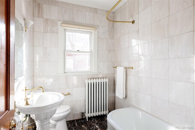 bathroom with tile walls, radiator heating unit, bathing tub / shower combination, and toilet