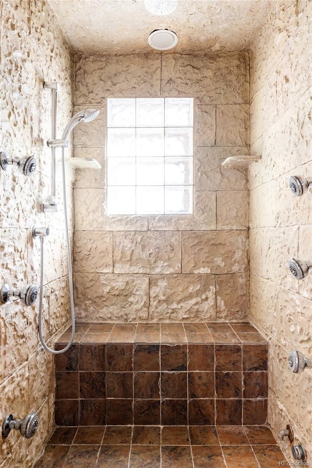 bathroom with a tile shower