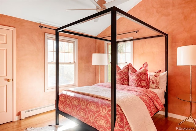 bedroom featuring hardwood / wood-style flooring, a baseboard radiator, and ceiling fan