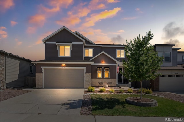 4778 Ravencrest Pl, Castle Rock, CO 80108 - view of front of property with stone siding, concrete driveway, an attached garage, and a lawn