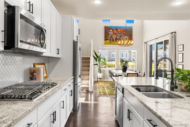 4778 Ravencrest Pl, Castle Rock, CO 80108 - kitchen featuring stainless steel appliances, dark wood-style flooring, recessed lighting, decorative backsplash, and white cabinets