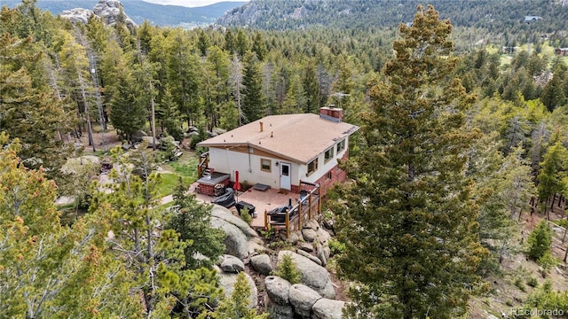 8701 Majestic View Dr, Conifer, CO 80433 - view from above of property featuring a heavily wooded area and a mountainous background