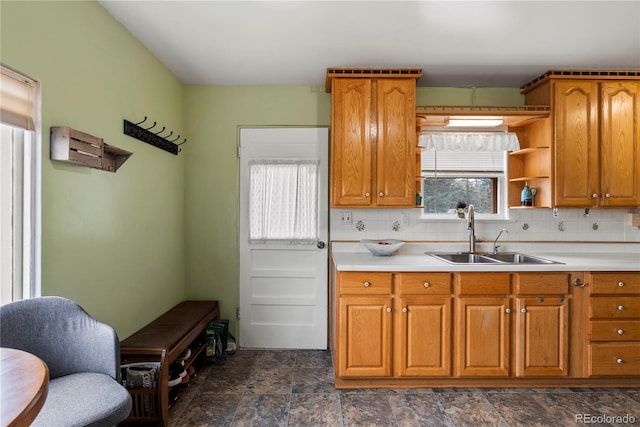 8701 Majestic View Dr, Conifer, CO 80433 - kitchen featuring a sink, brown cabinets, and decorative backsplash