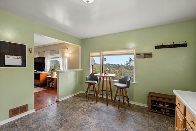 8701 Majestic View Dr, Conifer, CO 80433 - dining room featuring plenty of natural light, stone finish floors, and baseboards