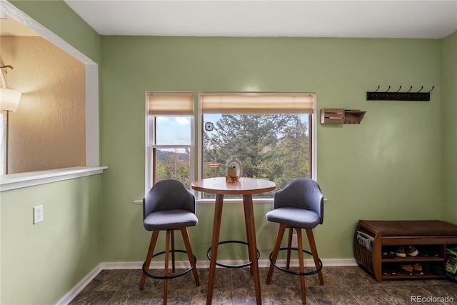 8701 Majestic View Dr, Conifer, CO 80433 - dining space with baseboards and dark stone finish floors