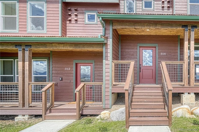 view of exterior entry with covered porch