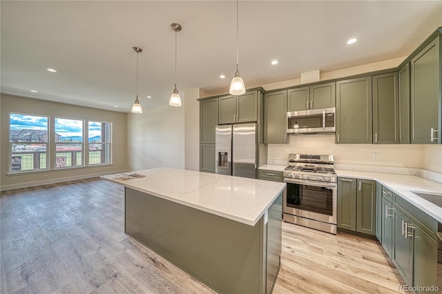 kitchen with a center island, hanging light fixtures, light hardwood / wood-style flooring, light stone countertops, and stainless steel appliances