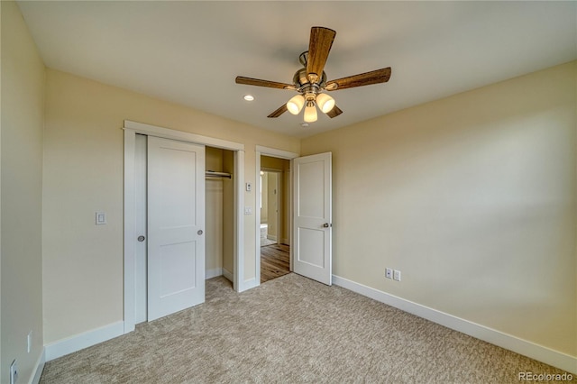 unfurnished bedroom featuring a closet, ceiling fan, and light colored carpet