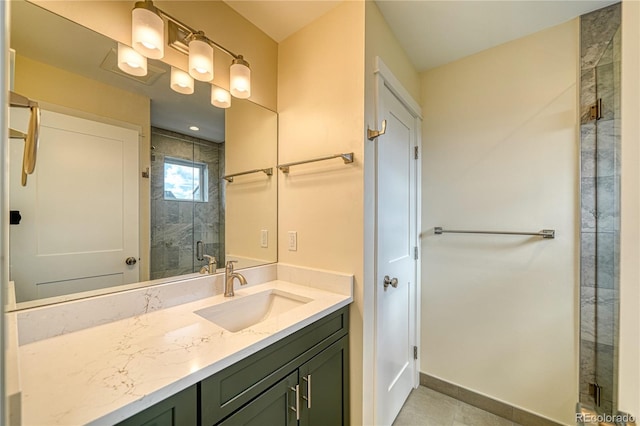 bathroom with tile patterned flooring, vanity, and a shower with door