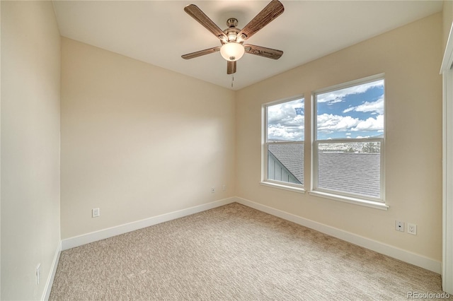 unfurnished room featuring ceiling fan and light colored carpet