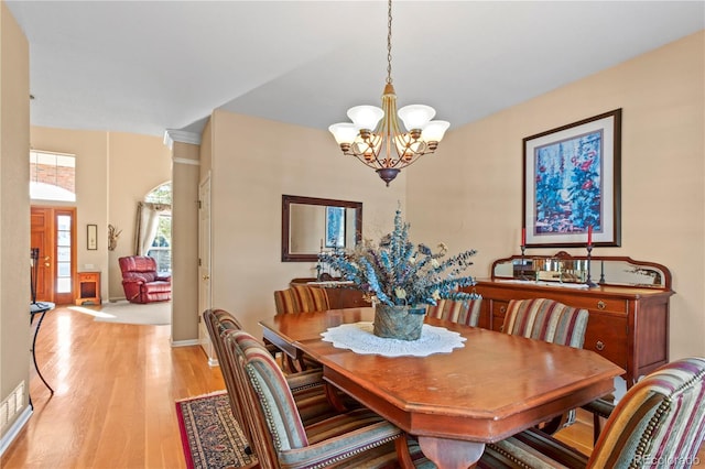 dining room featuring a notable chandelier and light hardwood / wood-style floors