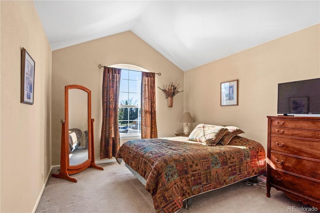 carpeted bedroom with lofted ceiling