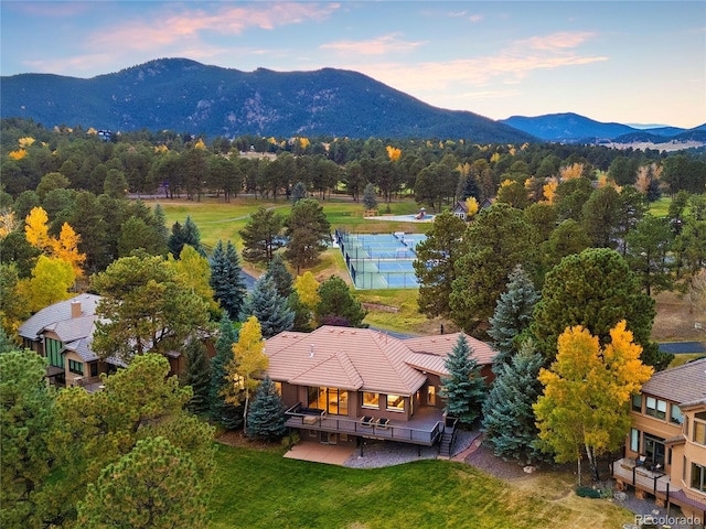 aerial view at dusk featuring a mountain view