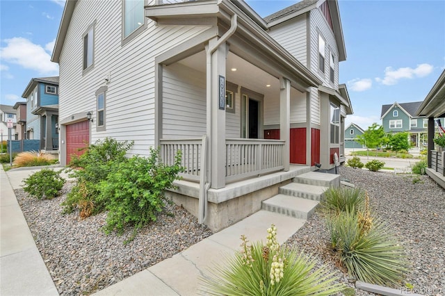 9307 Inca Dove Cir, Littleton, CO 80125 - view of front facade with a porch, a garage, and a residential view