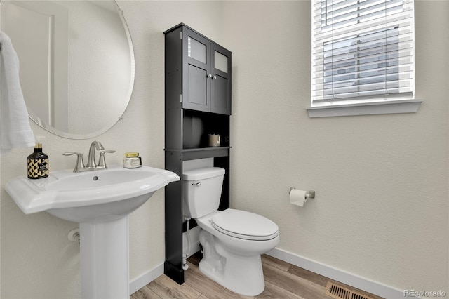 9307 Inca Dove Cir, Littleton, CO 80125 - half bath with toilet and wood finished floors