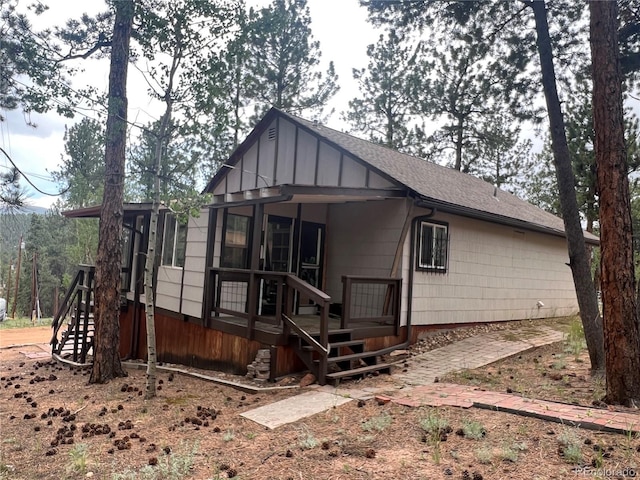 187 Johnson Rd, Bailey, CO 80421 - rear view of property with stairs, a shingled roof, and board and batten siding