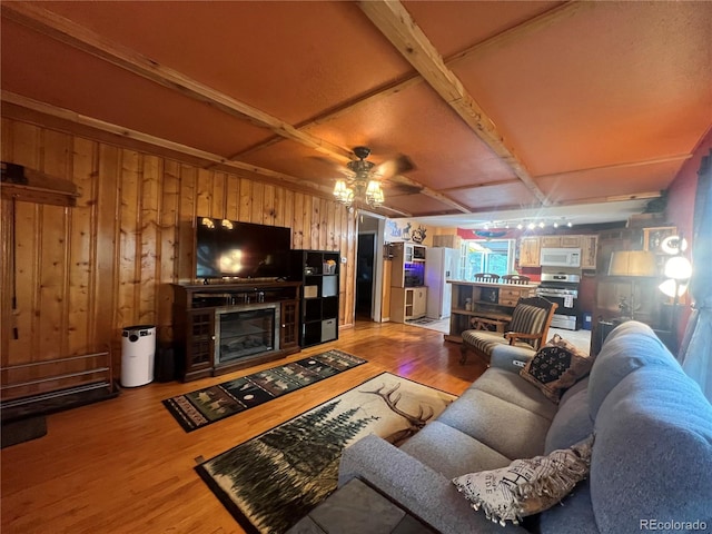 187 Johnson Rd, Bailey, CO 80421 - living area featuring light wood-style floors, wood walls, ceiling fan, and a fireplace