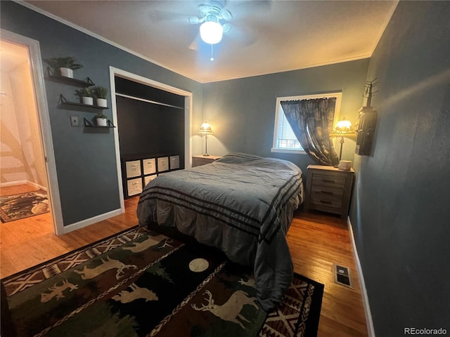 187 Johnson Rd, Bailey, CO 80421 - bedroom with wood finished floors, ornamental molding, ceiling fan, and a closet