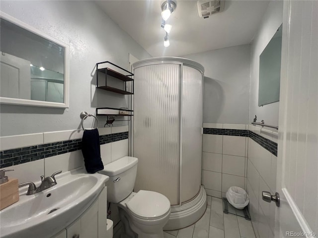 187 Johnson Rd, Bailey, CO 80421 - full bath featuring tile walls, a shower stall, vanity, and a wainscoted wall