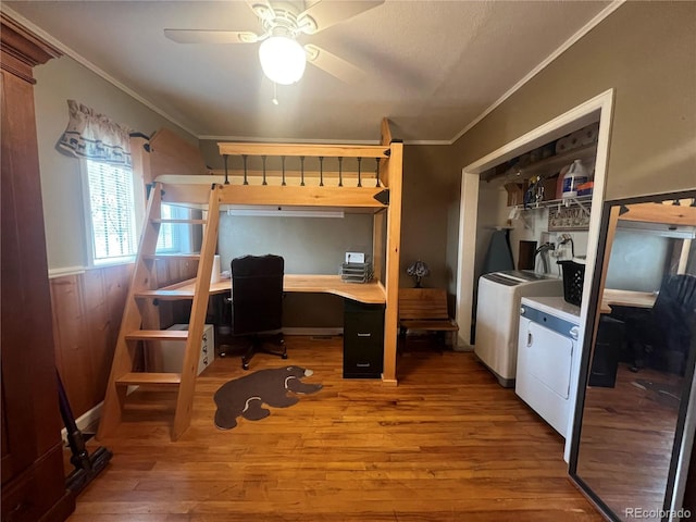 187 Johnson Rd, Bailey, CO 80421 - bedroom featuring washing machine and dryer, crown molding, wood finished floors, a desk, and a closet