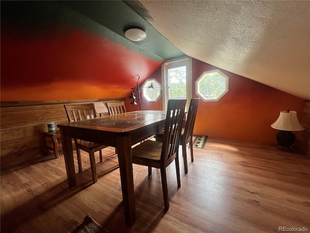 187 Johnson Rd, Bailey, CO 80421 - dining space featuring wood finished floors, a textured ceiling, and vaulted ceiling
