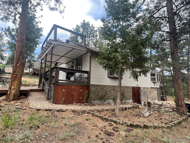 187 Johnson Rd, Bailey, CO 80421 - view of side of home with stone siding, a deck, and stairway
