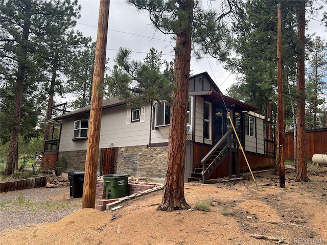 187 Johnson Rd, Bailey, CO 80421 - rear view of house with stone siding and stairway