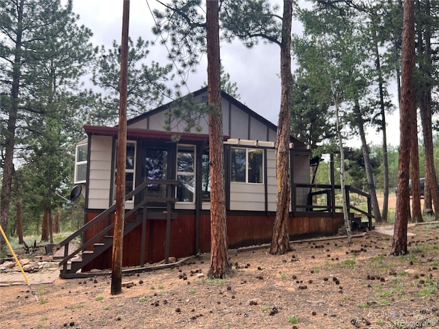 187 Johnson Rd, Bailey, CO 80421 - back of property featuring stairs and board and batten siding
