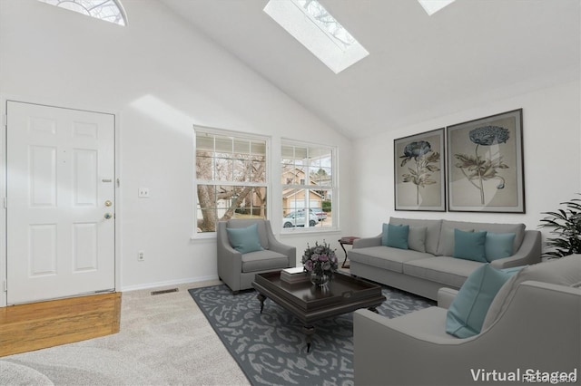 living room featuring high vaulted ceiling, a skylight, and carpet floors