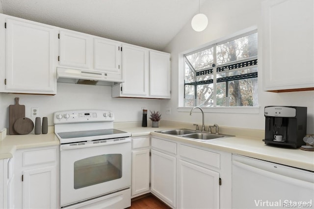 kitchen featuring white appliances, lofted ceiling, sink, and white cabinets