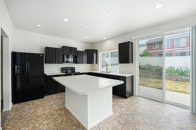 5550 Malta St, Denver, CO 80249 - kitchen featuring black appliances, light countertops, dark cabinets, recessed lighting, and a center island