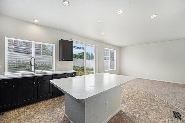 5550 Malta St, Denver, CO 80249 - kitchen with dark cabinets, recessed lighting, light countertops, a kitchen island, and open floor plan