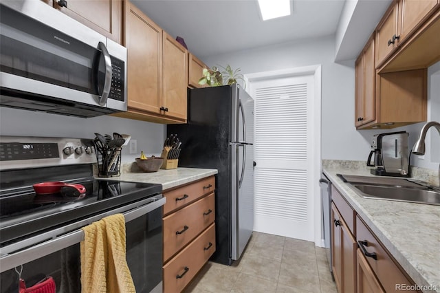 8751 Chase Dr Unit 181, Arvada, CO 80003 - kitchen with appliances with stainless steel finishes, light countertops, and light tile patterned floors