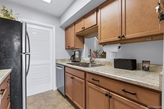 8751 Chase Dr Unit 181, Arvada, CO 80003 - kitchen featuring appliances with stainless steel finishes, light countertops, brown cabinets, and light tile patterned flooring