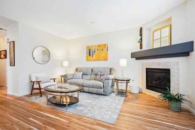 8520 S Holland Ln Unit 102, Littleton, CO 80128 - living area featuring wood finished floors, baseboards, and a fireplace