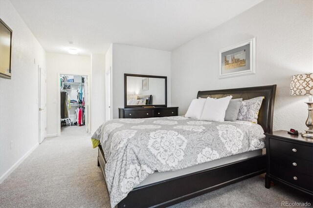 8520 S Holland Ln Unit 102, Littleton, CO 80128 - carpeted bedroom with a walk in closet, baseboards, and a closet