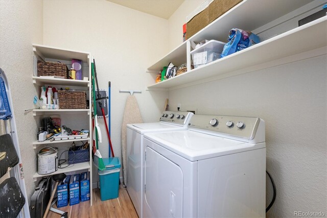 8520 S Holland Ln Unit 102, Littleton, CO 80128 - laundry room featuring separate washer and dryer and light wood finished floors